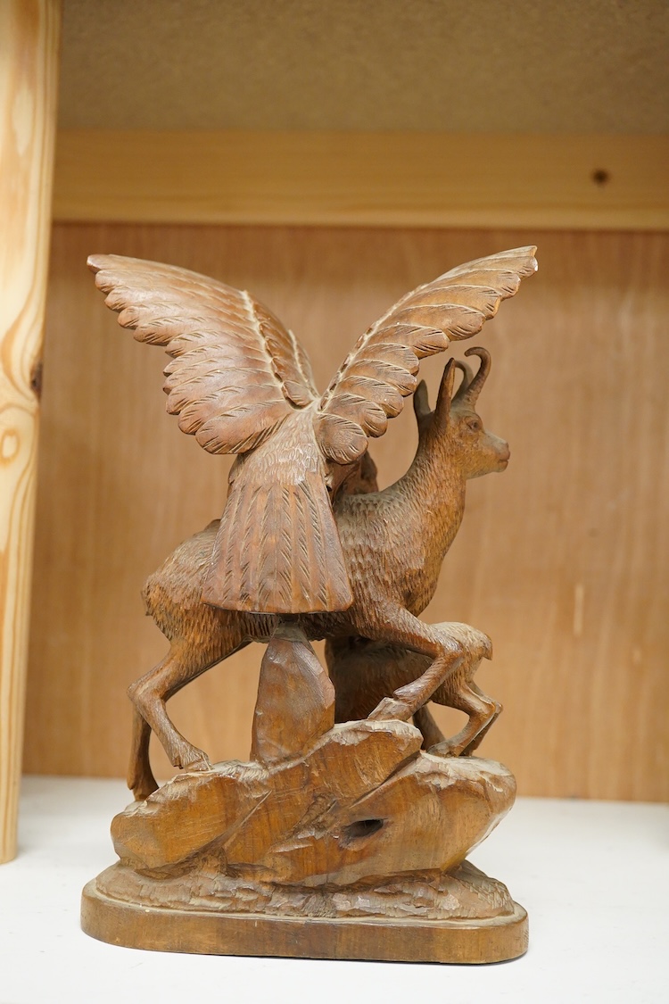 A late 19th century Black Forest carving, chamois group and eagle, 21cm
